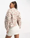 Wrangler all over monogram print co-ord denim jacket in brown